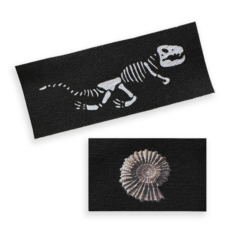 May include: Two black fabric patches with white designs. The first patch features a dinosaur skeleton. The second patch features a fossilized ammonite.