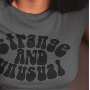 A Strange and Unusual T-Shirt for Unisex Adults Alternative Alt Plus Shirts Womens Mens Non-Binary Tshirt Espi Lane Asphalt