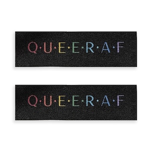 May include: Two black fabric labels with the text "Q.U.E.E.R.A.F" in rainbow colors.