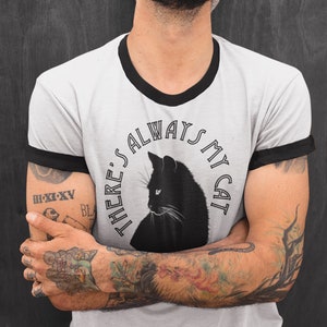 May include: A gray t-shirt with a black ringer and a black cat graphic. The graphic says "There's always my cat".