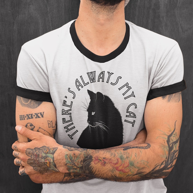 May include: A gray t-shirt with a black ringer and a black cat graphic. The graphic says "There's always my cat".