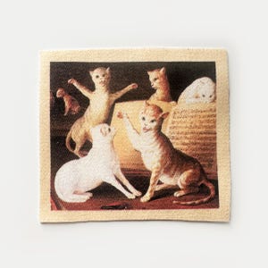 May include: Square fabric patch featuring a vintage-style painting of several cats in various poses. The cats are depicted in shades of white, tan, and brown, set against a warm, neutral background. The patch has a beige border.