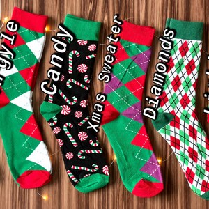 May include: Six pairs of Christmas themed socks with different patterns. The socks are green, red, and white with patterns of stripes, argyle, candy canes, Christmas sweaters, diamonds, and lights.