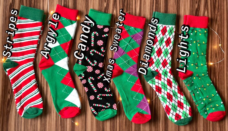 May include: Six pairs of Christmas themed socks with different patterns. The socks are green, red, and white with patterns of stripes, argyle, candy canes, Christmas sweaters, diamonds, and lights.