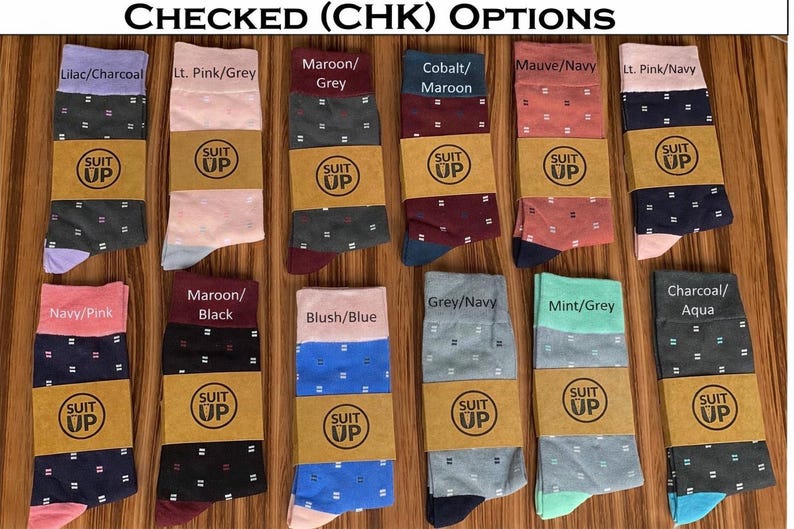 May include: A collection of patterned socks in various colors, including lilac, pink, maroon, cobalt, and navy. Each pair features a checked design and is labeled with color combinations. The socks are displayed on a wooden surface.