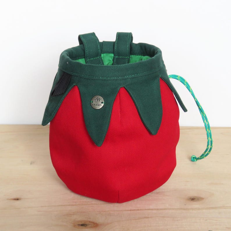red tomato shape with dark green leaves chalk bag for climbing in rock and gym