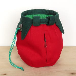 red tomato shape with dark green leaves chalk bag for climbing in rock and gym, back side with zippered pocket