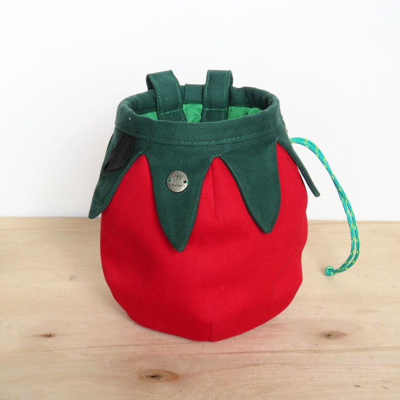 red tomato shape with dark green leaves chalk bag for climbing in rock and gym