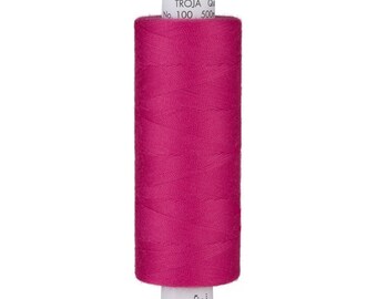 May include: A spool of pink sewing thread with the text "TROJA No. 100 500m" on the label.