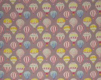 May include: A seamless pattern featuring a repeating design of hot air balloons in various colors, including pink, yellow, blue, and white. The balloons are depicted against a light purple background.
