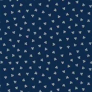 Peut inclure: Un tissu bleu foncé avec un motif blanc répétitif de petites feuilles stylisées.