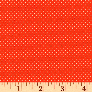 Könnte beinhalten: Roter Stoff mit weißen Punkten. Der Stoff wird mit einem Lineal in Zoll gemessen.