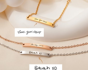 May include: Three gold, rose gold, and silver bar bracelets with handwritten messages on the bars. The gold bar says "Love you Mom", the rose gold bar says "Love you more", and the silver bar says "Sarah XO".
