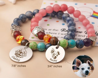 May include: Two beaded bracelets with personalized dog tags. One bracelet features blue and multicolored beads, the other pink. The tags are engraved with dog portraits and names, one reading "Oakley" and the other "Rocky". The Oakley tag is 7/8 inches, and the Rocky tag is 3/4 inches.