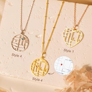 May include: Three necklaces with map-like pendant designs. One is silver with a blue gem, another is gold, and the third is rose gold in a heart shape. The pendants have a city map design. The text "Style 4" and "Style 1" are visible.