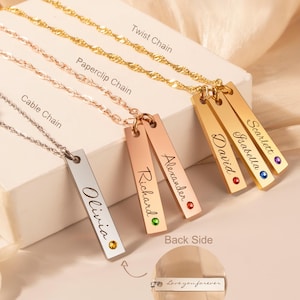 May include: Five gold bar necklaces with different names engraved on them. Each necklace has a small gemstone on the bar. The necklaces are displayed on a white surface with the words "Twist Chain", "Paperclip Chain", "Cable Chain", "Back Side", and "Love you forever" written on the surface.
