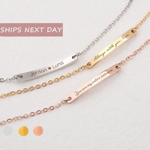 May include: Three silver, gold, and rose gold bar bracelets with personalized engravings. The silver bracelet says "Jordan Luna" with a heart symbol between the names. The gold bracelet says "Always with you. Tina". The rose gold bracelet says "You are my entire universe".