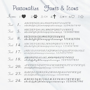 May include: A chart with a list of fonts and icons for personalization. The chart includes a heart, paw print, fish, cross, arrow, star, and numbers 1, 2, 3, 4, 5, 6, 7, 8, 14, 17, 18, 20, 23, and 24. The chart also includes the alphabet in uppercase and lowercase letters for each font.