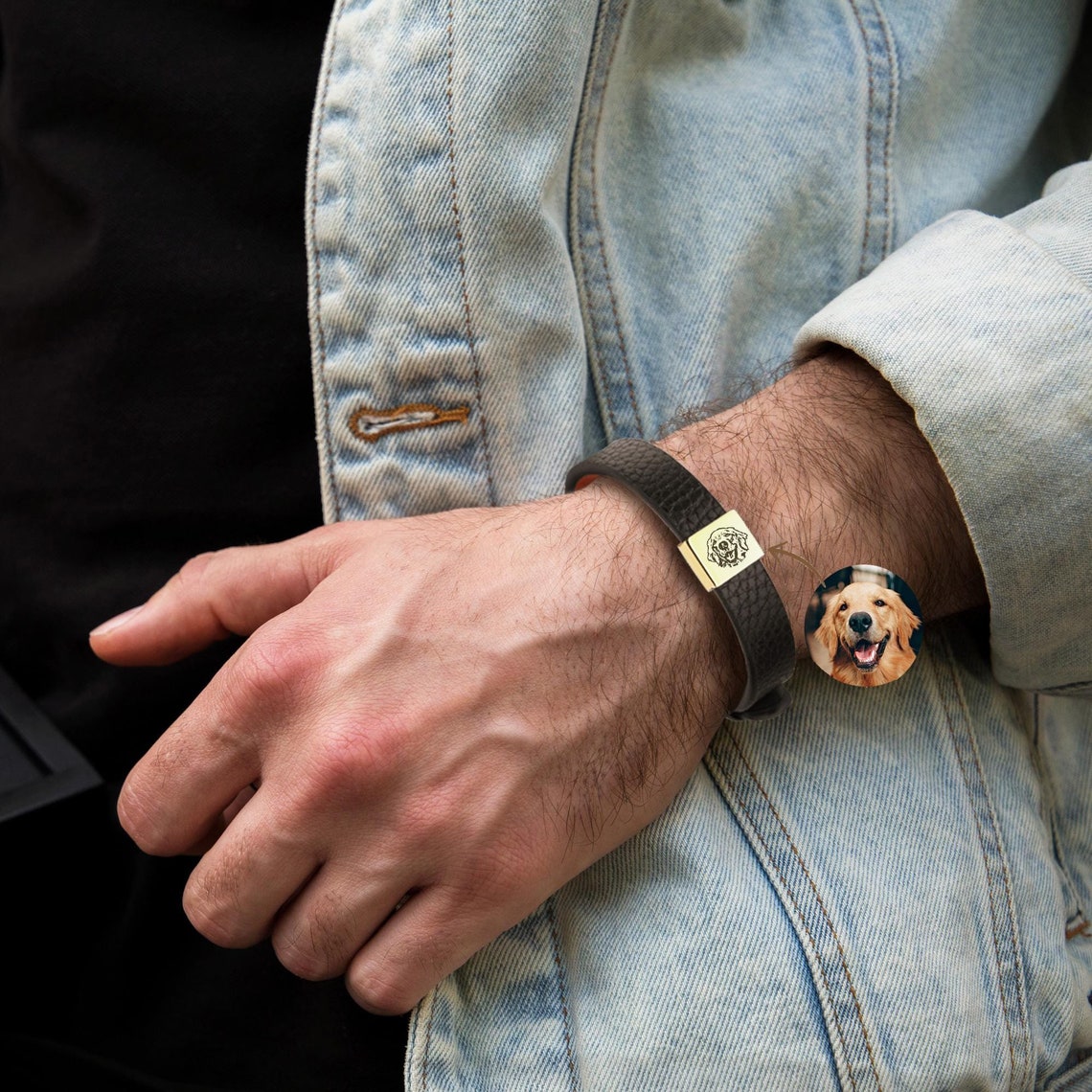 A man wearing a pet portrait leather bracelet of his Golden Retriever.