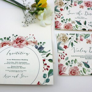 May include: A set of three wedding invitations with a floral design. The invitations are printed on white cardstock and feature watercolour illustrations of pink and red roses, green leaves, and blue flowers. The text on the invitations reads "Invitation", "Save the Date", and "Vielen Dank".