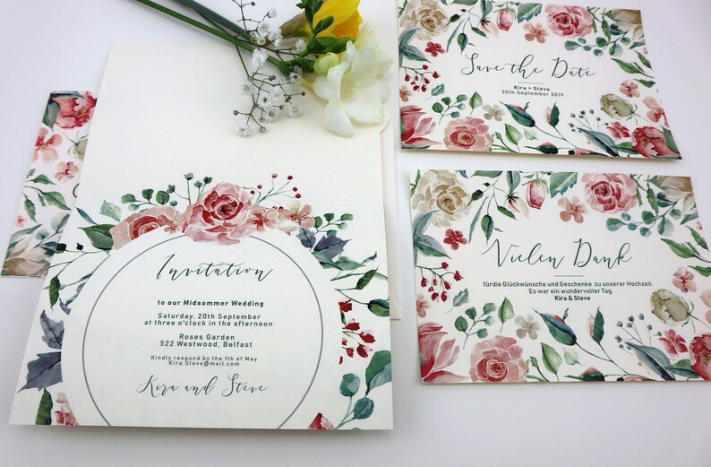 May include: A set of three wedding invitations with a floral design. The invitations are printed on white cardstock and feature watercolour illustrations of pink and red roses, green leaves, and blue flowers. The text on the invitations reads "Invitation", "Save the Date", and "Vielen Dank".