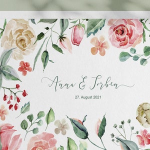 May include: A watercolour wedding invitation with a floral border. The invitation features pink, peach, and green flowers and leaves. The text on the invitation reads "Anna & Torben, 27. August 2021".