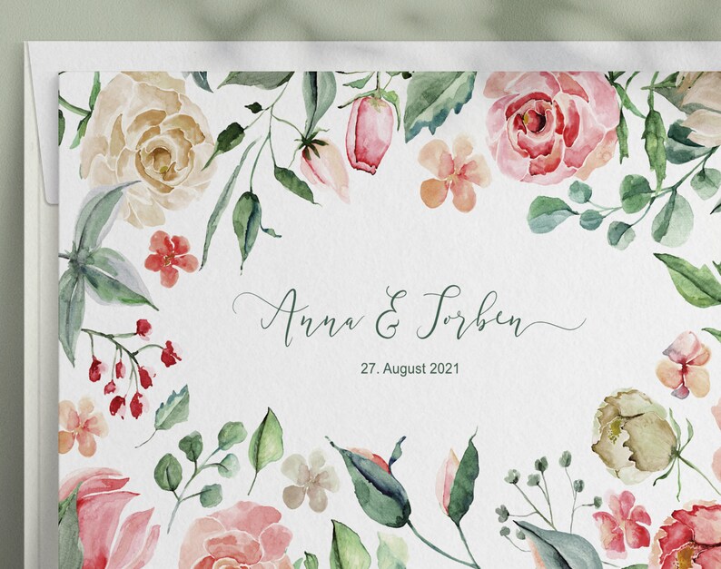 May include: A watercolour wedding invitation with a floral border. The invitation features pink, peach, and green flowers and leaves. The text on the invitation reads "Anna & Torben, 27. August 2021".