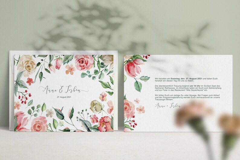 May include: A wedding invitation with a floral design featuring pink and white flowers. The text on the invitation reads "Anna & Sorben 27 August 2021".