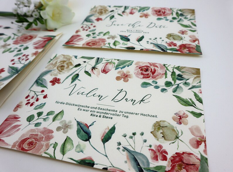 May include: A white card with a floral design and the text "Vielen Dank" for the congratulations and gifts for our wedding. It was a wonderful day. Kira & Steve.