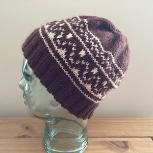 Een handgebreide Fair Isle-beanie voor heren in bruin/crème, maat M, nieuw.