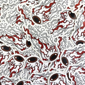 This image shows a pile of melting eyeball / evil eye stickers covering the entire image.