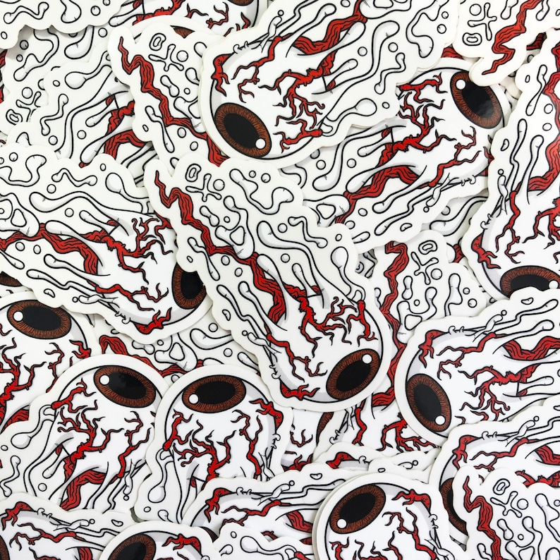 This image shows a pile of melting eyeball / evil eye stickers covering the entire image.