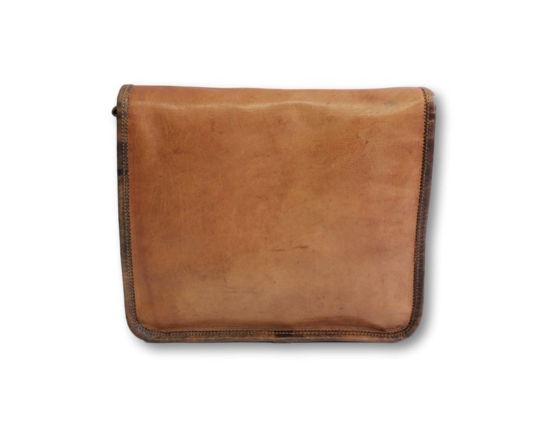 May include: A brown leather messenger bag with a flap closure and a brown strap. The bag has a worn, vintage look.