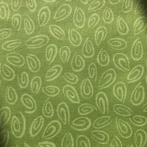 Può includere: Tessuto verde con un motivo bianco di foglie e ovali a spirale.