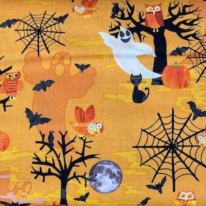 May include: A yellow fabric with a Halloween theme featuring ghosts, owls, bats, spiders, and pumpkins.