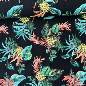 May include: Black fabric with a tropical print featuring pineapples and palm leaves in shades of green, yellow, and pink.