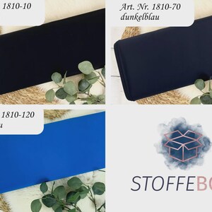 May include: Three fabric swatches in black, dark blue, and royal blue. The swatches are laid out on a woven surface with green leafy branches. The text "Art. Nr. 1810-10 schwarz", "Art. Nr. 1810-70 dunkelblau", and "Art. Nr. 1810-120 royalblau" is visible above each swatch. The text "STOFFEBOX" is visible in the bottom right corner of the image.