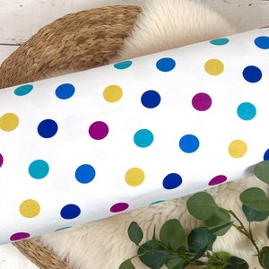 May include: White fabric with a colorful polka dot pattern. The dots are yellow, blue, teal, and magenta.