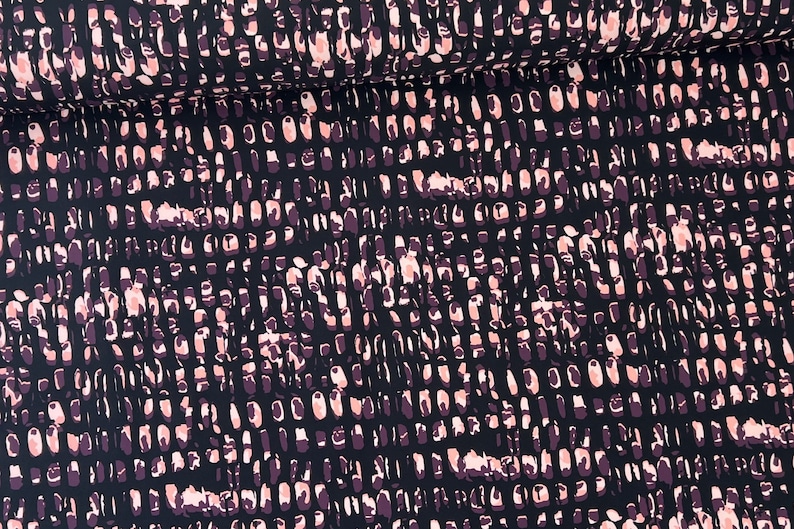 May include: Black fabric with a repeating pattern of pink and purple abstract shapes.