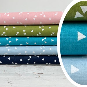 Può includere: Cinque rotoli di tessuto con un motivo a triangoli bianchi su sfondi di diversi colori. I colori sono rosa, verde, turchese, azzurro e blu scuro.