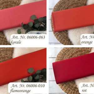 May include: Four fabric swatches in different shades of red and orange. The swatches are labeled with their corresponding article numbers and color names: "Art. Nr. 06006-063 korale", "Art. Nr. 06006-0039 orange", "Art. Nr. 06006-010 flameorange", and "Art. Nr. 06006-018 rot".