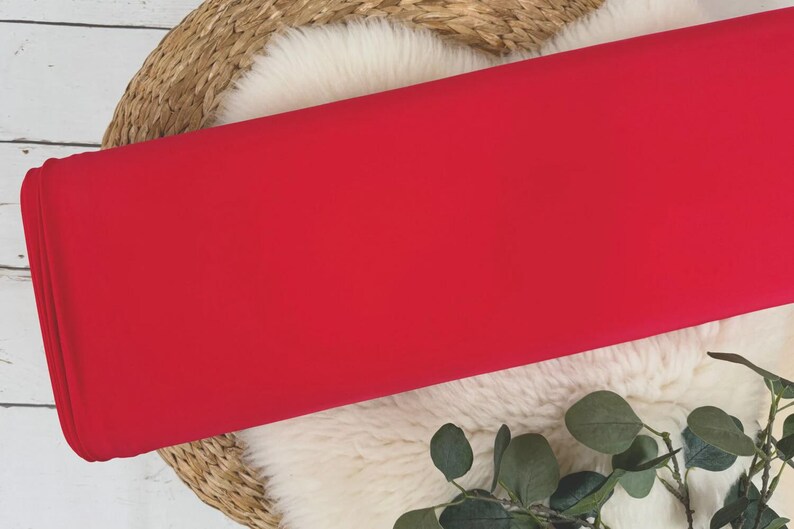 May include: A bright red fabric swatch, perfect for crafting projects or sewing garments.