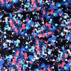 May include: Black fabric with a watercolour floral print in shades of blue, pink, and white.