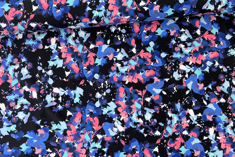 May include: Black fabric with a watercolour floral print in shades of blue, pink, and white.