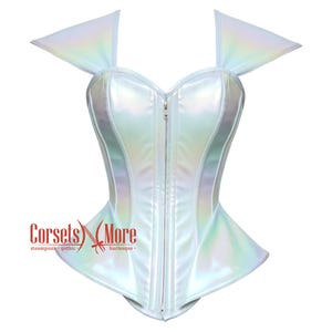 May include: A white iridescent corset with a zipper closure and a sweetheart neckline. The corset has a fitted bodice and a flared skirt. The straps are wide and have a pointed shape. The corset is made of a shiny, satin-like material.