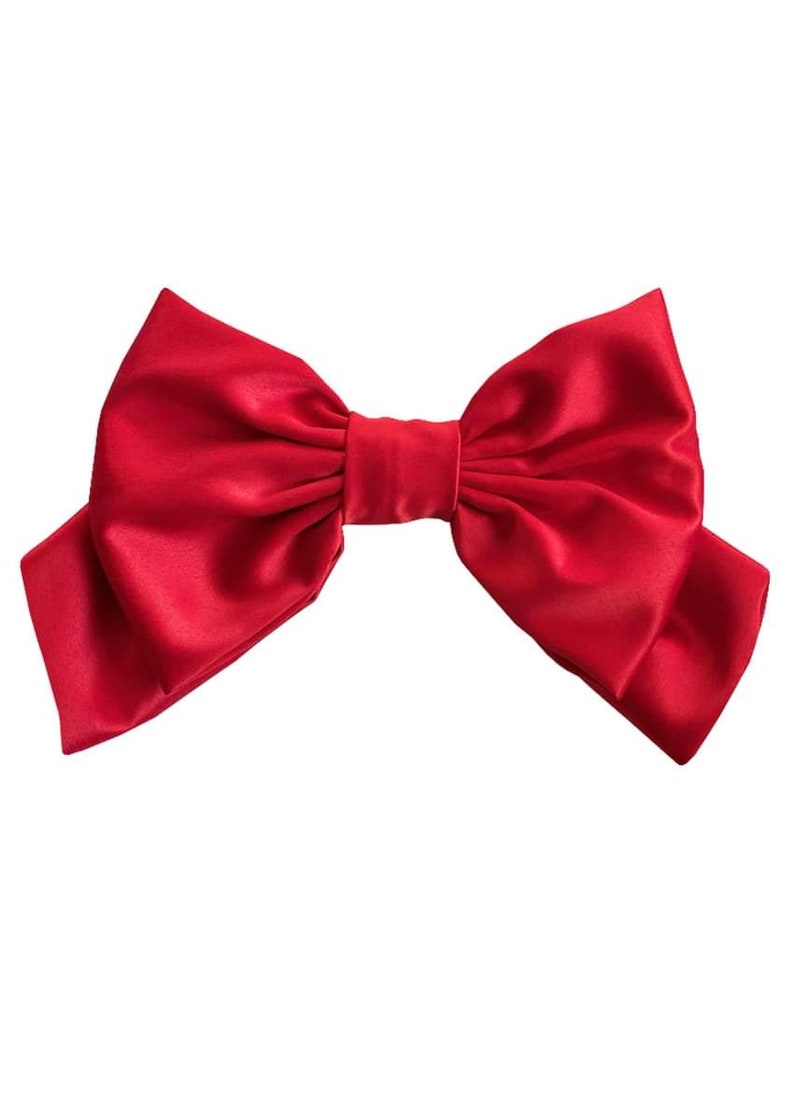 May include: A large, red satin bow. The bow is tied in a classic style with two loops and a center knot.