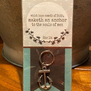 May include: A silver anchor keychain with a white card that reads "which hope cometh of faith, maketh an anchor to the souls of men Ether 12:4" with a decorative border of anchors.