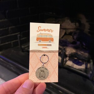 May include: A white card with the text "Summer" and a cartoon image of a vintage van with a surfboard on top. The card has a progress bar that says "LOADING..." and a silver keychain with the text "Let's Get Lost" and a cartoon image of a vintage van with a surfboard on top.