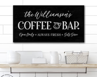May include: A rectangular black sign with white text reading the Williamson's COFFEE BAR, Open Daily, ALWAYS FRESH, and Self Serve, featuring a small pitcher graphic. The sign has a wood grain texture and is framed in a thin black border.