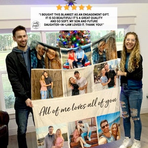 May include: A personalized photo blanket with a collage of photos of a couple. The blanket is beige with a white border and the text "All of me loves all of you" in black cursive writing.